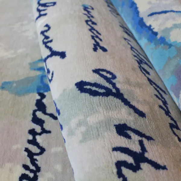 Bespoke handknotted rug in pure wool based on a handwritten letter family heirloom. Colours are cream and various shades of blue