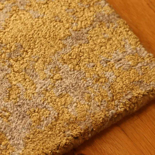 Closeup to handknotted rug in golden shades using pure silk and undyed nettle (2)