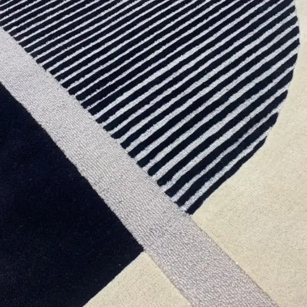 Combining loop pile with cut pile for understated textured rugs, geometric striped cream and black rug