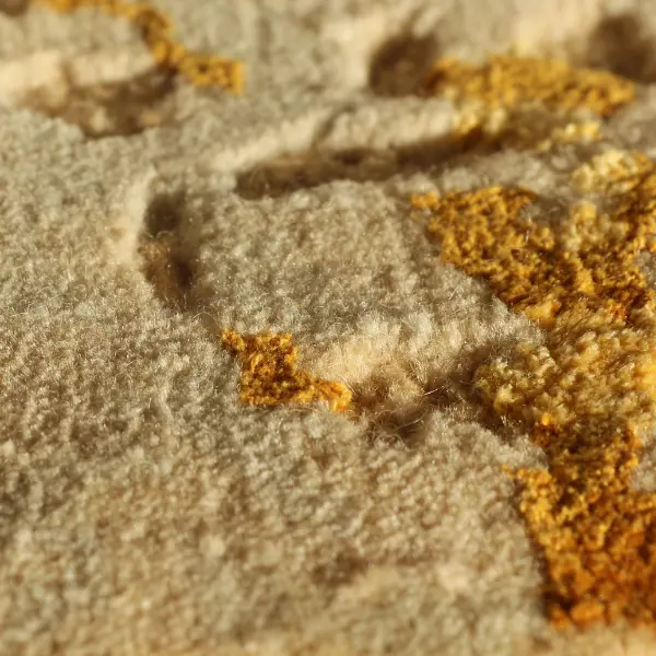Side view of handknotted rug in wool and silk, combining loop pile in low pile with cut pile in high pile