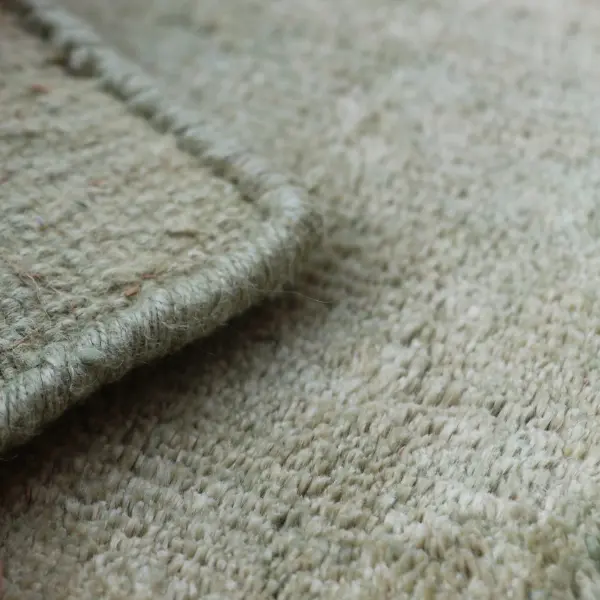 Linen rug closeup showing the front and the back of the rug