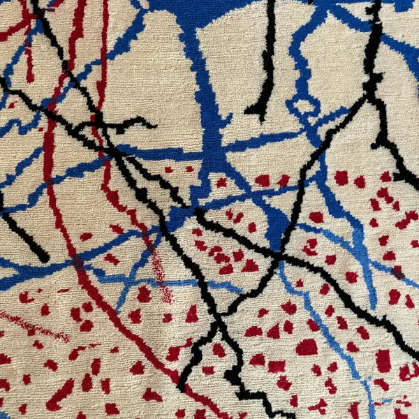 Gros plan d'un luxueux tapis noué à la main d'après le dessin de Ramon y Cajal, beige, rouge, vert, noir, bleu.
