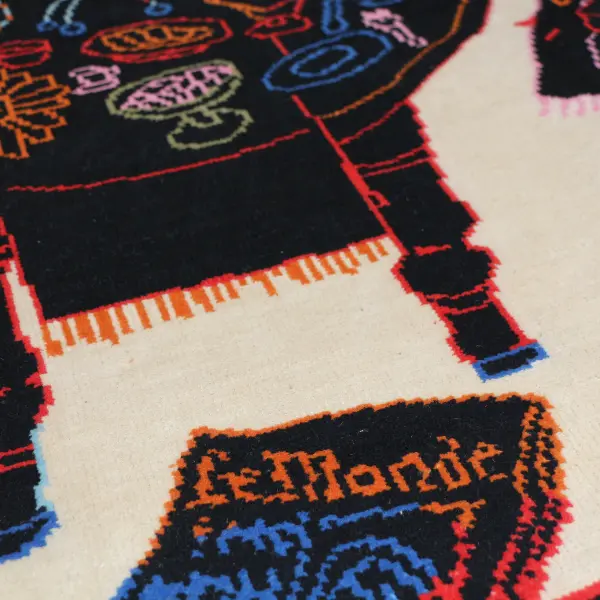 Handknotted rug with black dining table and colourful items in Paris