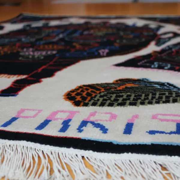 Handknotted rug with black dining table and colourful items in Paris
