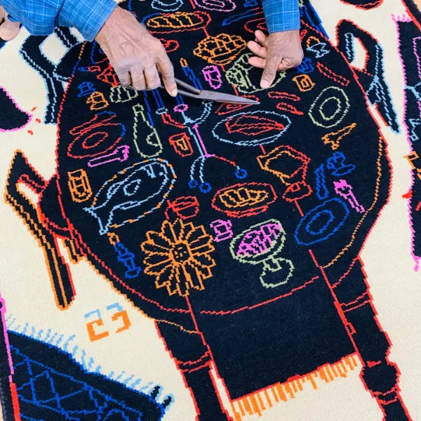 Handknotted rug with black dining table and colourful items in Paris