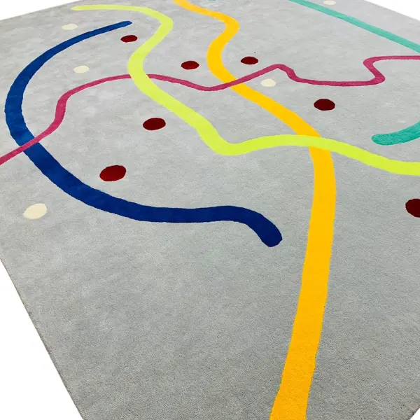 Tapis tufté à la main inspiré par le plan du métro parisien, dans un style moderne et minimaliste, dans les couleurs gris, rose, vert, jaune et turquoise.