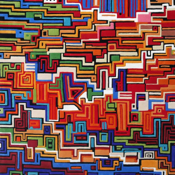 Tapis tufté à la main avec différentes hauteurs de poils et des lignes arrondies, très coloré, rappelant une ville imaginaire.