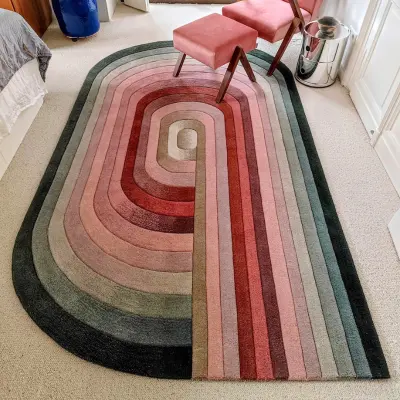 Handtufted rug in pink, cream, and green gradients to match the interior in the master bedroom. With spiral, curved shape