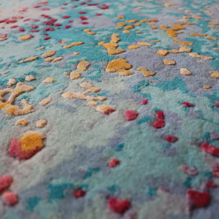 Close-up of the handmade rug by Sabine Oecking in turquoise, lilac and yellow