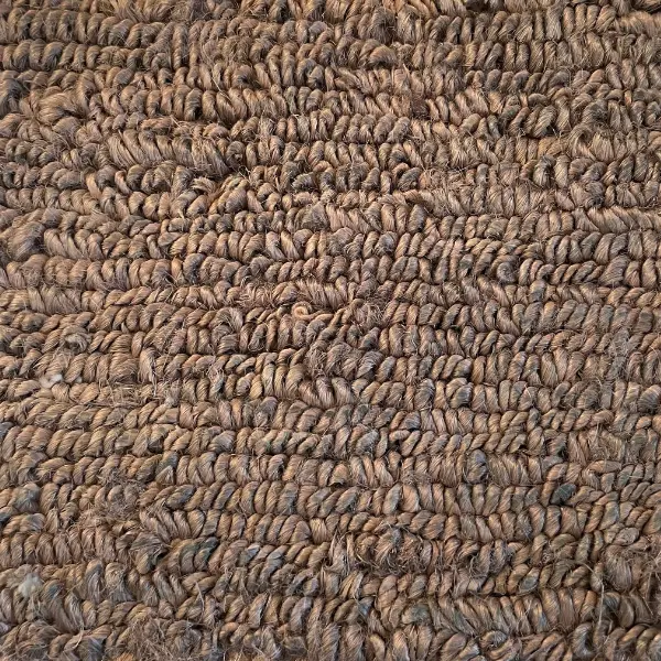 Primer plano de una alfombra de cáñamo, en el que se aprecia su textura robusta y característica